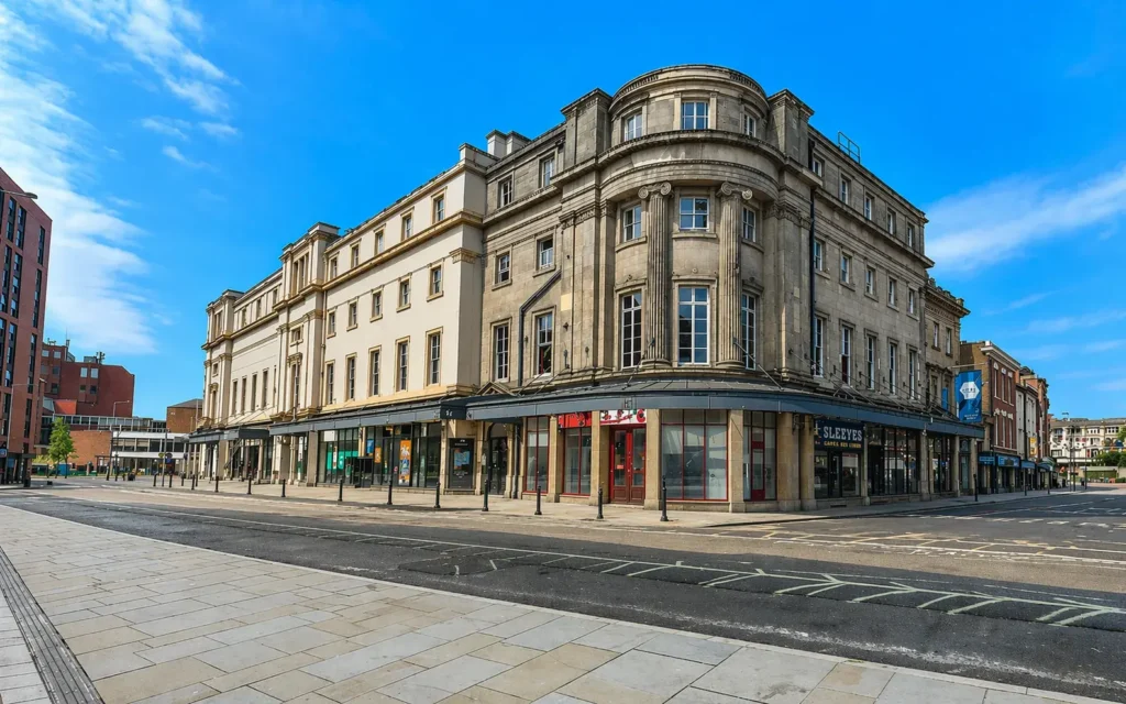 Street view of The Royal Buildings in Derby city centre, showing the ground-floor commercial frontage