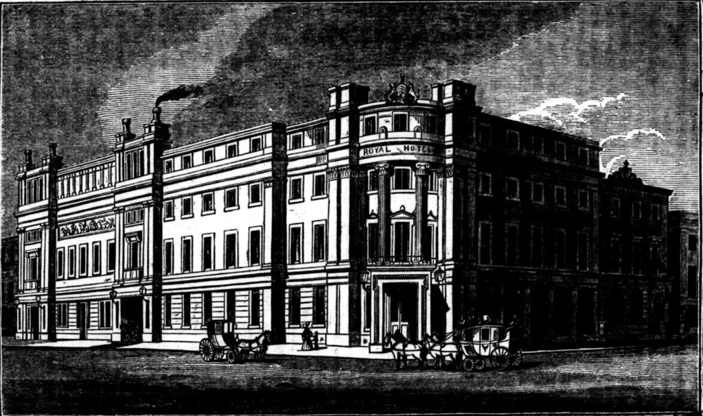 1839 wood engraving of the newly built Royal Hotel, Derby, with Royal Hotel lettered on the curved corner, the royal coat of arms above, and horse-drawn coaches in the street outside